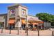 Casual Urban Eatery restaurant featuring an outdoor seating area with orange umbrellas and covered patio at 755 Roslyn St # 17, Denver, CO 80230