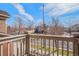 Balcony with a view of a quiet street, mature trees, and residential homes at 755 Roslyn St # 17, Denver, CO 80230
