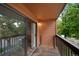 Outdoor balcony showcasing wood flooring and views of the surrounding lush trees at 451 Wright St # 11, Lakewood, CO 80228
