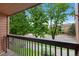 Balcony view showcasing a peaceful street with mature trees and residential buildings at 451 Wright St # 11, Lakewood, CO 80228