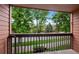 Balcony view showcasing a peaceful street with mature trees and residential buildings at 451 Wright St # 11, Lakewood, CO 80228