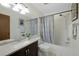 Well-lit bathroom with a shower-tub combo, vanity with sink, and neutral decor at 451 Wright St # 11, Lakewood, CO 80228