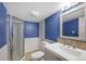 Bathroom with blue walls, shower, updated vanity, mirror and lighting at 451 Wright St # 11, Lakewood, CO 80228