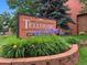 Exterior view of the Telluride community sign surrounded by lush greenery and colorful flowers at 451 Wright St # 11, Lakewood, CO 80228