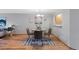 A dining room with modern decor, including a round table, stylish chairs, and contemporary artwork at 451 Wright St # 11, Lakewood, CO 80228