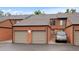 View of home garages with brown trim and an SUV parked in driveway at 451 Wright St # 11, Lakewood, CO 80228
