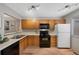 Functional kitchen featuring wood cabinetry, essential appliances, and great natural light at 451 Wright St # 11, Lakewood, CO 80228