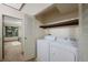 This laundry room includes a washer and dryer along with shelving for storage at 451 Wright St # 11, Lakewood, CO 80228