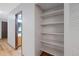 Walk-in pantry featuring white shelving offering generous storage space and easy organization at 451 Wright St # 11, Lakewood, CO 80228