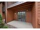 Exterior patio area with sliding glass door, brown siding and stone groundcover at 451 Wright St # 11, Lakewood, CO 80228