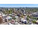 Expansive aerial view of Denver showcasing buildings, a park, and roads set against a clear sky and distant mountain range at 590 N Logan St # 303, Denver, CO 80203
