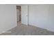 Neutral bedroom with soft carpeting, closet storage, and an interior view of the kitchen at 590 N Logan St # 303, Denver, CO 80203