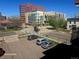 Street view with parked cars and modern buildings in the background at 590 N Logan St # 303, Denver, CO 80203