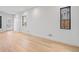 Minimalist living room with bright hardwood floors, white walls, and modern windows offering natural light and a clean aesthetic at 1250 Yates St, Denver, CO 80204