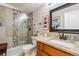 Bathroom featuring a granite countertop vanity and glass-enclosed shower at 9320 E Center Ave # 7A, Denver, CO 80247