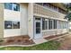 Corner condo unit featuring a sunroom, decorative facade, and partial lawn at 9320 E Center Ave # 7A, Denver, CO 80247