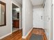 Hallway with wood-look flooring, closet and glimpse into the bathroom at 9320 E Center Ave # 7A, Denver, CO 80247