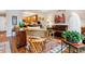 Open concept living room with wood floors leading to the kitchen, comfortable leather seating, and bright lighting at 9320 E Center Ave # 7A, Denver, CO 80247