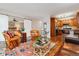 Open concept living room with wood floors flowing into the kitchen and bedroom, accented by comfortable leather seating at 9320 E Center Ave # 7A, Denver, CO 80247