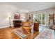 Comfortable living room with wood floors, area rug, leather seating, plants, and sliding glass doors at 9320 E Center Ave # 7A, Denver, CO 80247