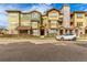 Attractive condo building with colorful siding, stone accents, and well-maintained landscaping at 15455 Canyon Rim Dr # 304, Englewood, CO 80112