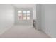 Spacious living room boasts natural light with a fireplace and neutral carpet at 15455 Canyon Rim Dr # 304, Englewood, CO 80112