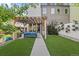 Well-maintained backyard with a pergola, manicured lawn, and flower boxes, ideal for relaxing or gardening at 2420 S Gilpin St, Denver, CO 80210