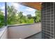 Private balcony with a modern design, offering a serene view of lush green trees at 2420 S Gilpin St, Denver, CO 80210