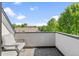 Relaxing balcony space with comfortable seating and scenic views of surrounding trees and sky at 2420 S Gilpin St, Denver, CO 80210
