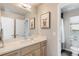 Bright bathroom featuring a spacious vanity with double sinks and a framed raccoon picture at 2420 S Gilpin St, Denver, CO 80210