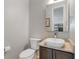 Modern half bathroom with a stylish vessel sink, updated fixtures, and a clean, minimalist design at 2420 S Gilpin St, Denver, CO 80210