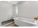 Spa-like bathroom with a freestanding tub, walk-in shower, and elegant finishes at 2420 S Gilpin St, Denver, CO 80210