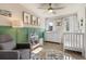Adorable Bedroom with a rocking chair, crib, and stylish decor, creating a cozy and welcoming space at 2420 S Gilpin St, Denver, CO 80210