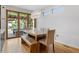 An elegant dining space adjacent to the kitchen features an outdoor view and modern lighting fixtures at 2420 S Gilpin St, Denver, CO 80210