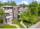 Aerial view of a modern three-story home featuring a brick facade, manicured lawn, and inviting outdoor spaces at 2420 S Gilpin St, Denver, CO 80210