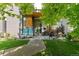 Charming home's front entrance with cozy seating, modern design, and inviting walkway at 2420 S Gilpin St, Denver, CO 80210