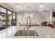 Bright kitchen featuring a stainless steel sink, modern faucet, and stylish pendant lighting at 2420 S Gilpin St, Denver, CO 80210