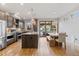 Open kitchen and dining area with an island, stainless steel appliances, and seamless indoor-outdoor flow at 2420 S Gilpin St, Denver, CO 80210
