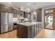 Gourmet kitchen featuring a large island, stainless steel appliances, and elegant dark wood cabinetry at 2420 S Gilpin St, Denver, CO 80210
