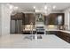 Well-appointed kitchen featuring a central island with a sink, stainless steel appliances, and pendant lighting at 2420 S Gilpin St, Denver, CO 80210