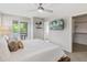 Sunlit main bedroom featuring a ceiling fan, balcony access, and a walk-in closet at 2420 S Gilpin St, Denver, CO 80210