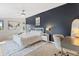 Spacious bedroom with a decorative accent wall, stylish furnishings, and a ceiling fan at 2420 S Gilpin St, Denver, CO 80210