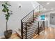 Contemporary staircase with metal railings, wood steps, and natural light, creating a stylish transition at 2420 S Gilpin St, Denver, CO 80210