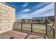 A cozy balcony with wood-look flooring, metal railings, and views of the community at 9023 E Northfield Blvd, Denver, CO 80238
