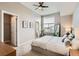 Serene bedroom featuring a large window, neutral tones, and a ceiling fan at 9023 E Northfield Blvd, Denver, CO 80238