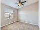 Neutral bedroom features a large window that brings in natural light and ceiling fan at 9023 E Northfield Blvd, Denver, CO 80238
