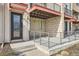 Modern townhouse exterior with a covered porch, minimalist landscaping, and a contemporary design at 9023 E Northfield Blvd, Denver, CO 80238