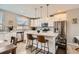 Bright, open kitchen featuring stainless steel appliances, a large island, and sleek white cabinetry at 9023 E Northfield Blvd, Denver, CO 80238