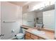 Bathroom with a sink, mirror, toilet, and a laundry area with a washing machine and dryer at 13351 W Alameda Pkwy # 203, Lakewood, CO 80228
