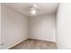 A simple, unfurnished bedroom features neutral walls, neutral carpet, and a ceiling fan at 13351 W Alameda Pkwy # 203, Lakewood, CO 80228